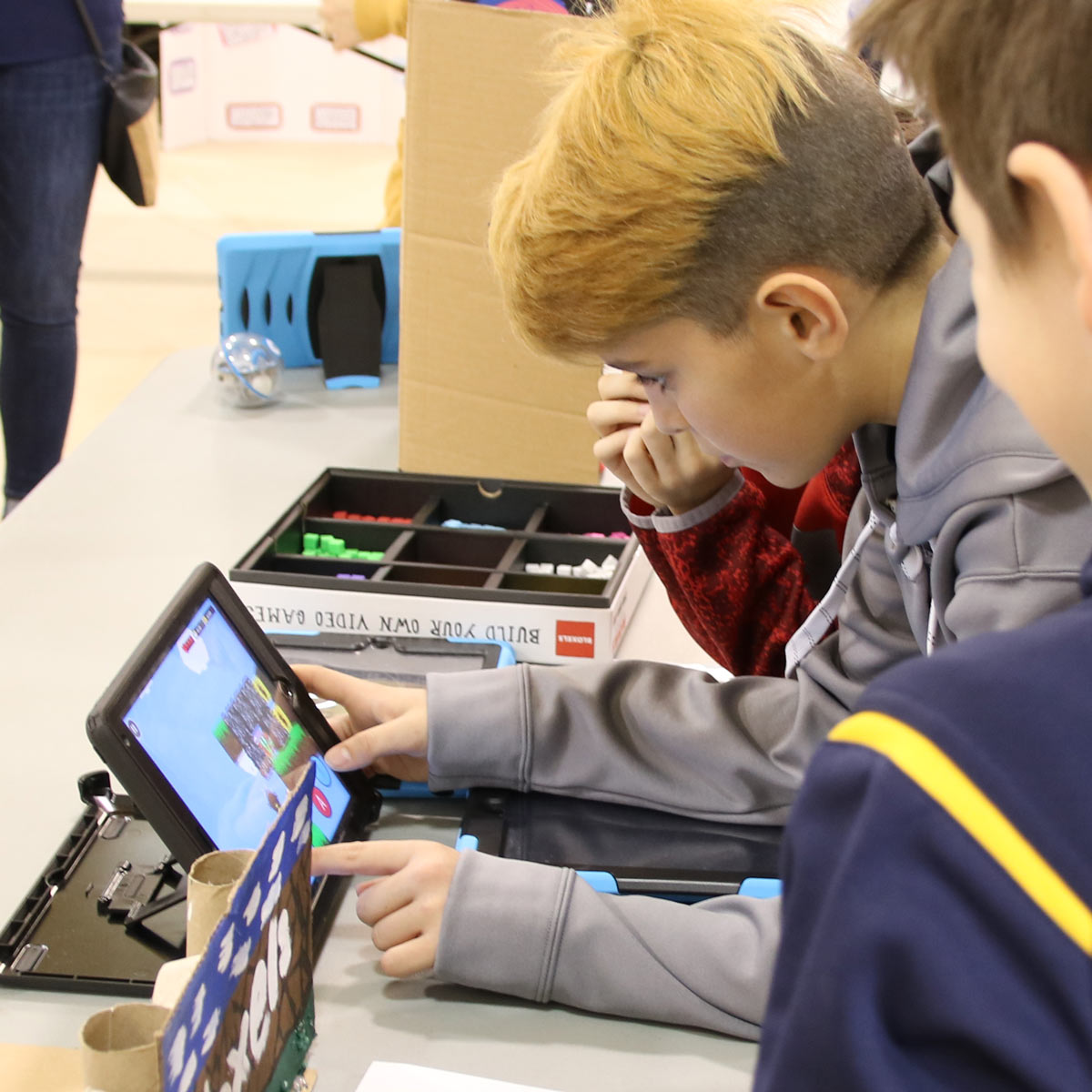 boy coding a tablet